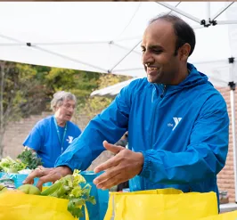 YMCA employee packing food for community outreach