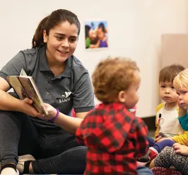 Early learning teacher reading to toddlers
