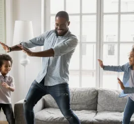 a father dancing with his 2 younger children