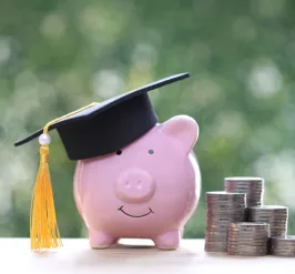 a piggy bank with coins stacked next to it