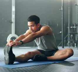 man stretching at the gym