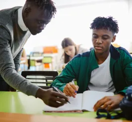 teacher helping a student with their works