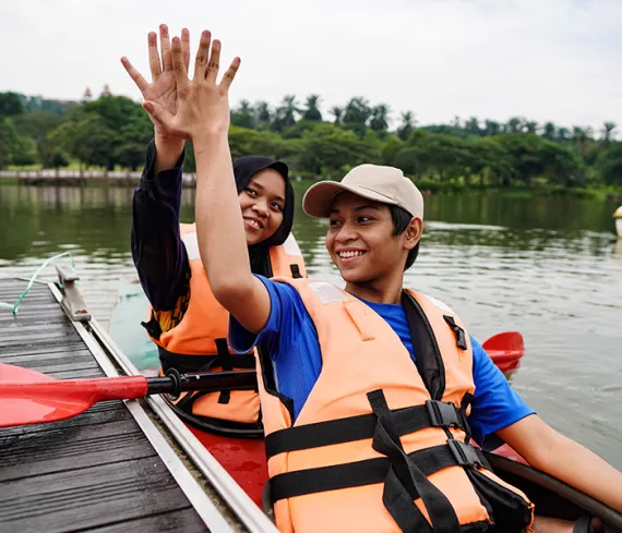 2 teenagers in a kayak