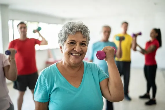 Active older adult curling a dumbbell