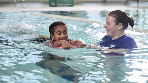 YMCA swim instructor teaching a swim lesson with a participant 