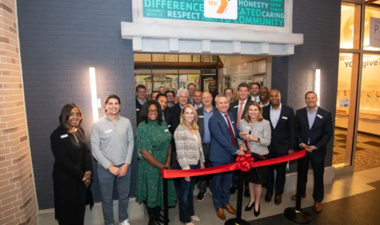 board members and senior leadership cutting ribbon at YMCA Junior Achievement at Storefront 