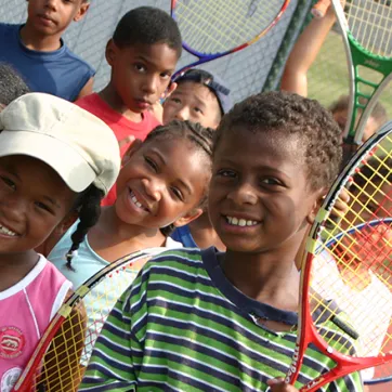 Smiling kids with tennis rackets