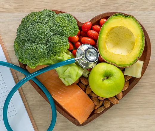 Bowl of healthy fruits and vegetables with a stethescope
