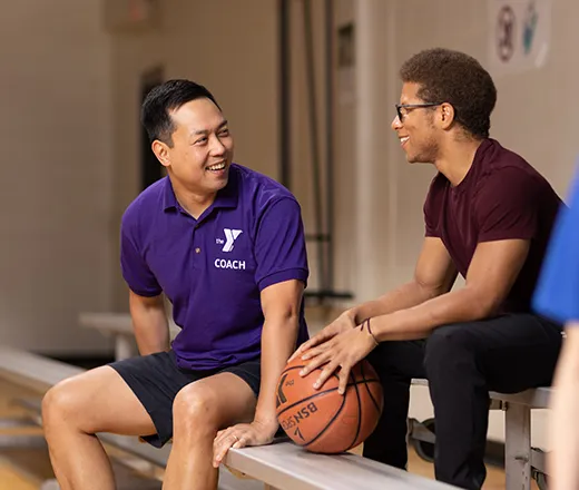 YMCA basketball caoach talking with a member
