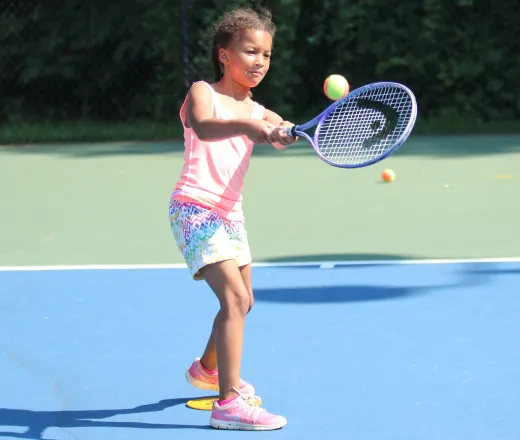young girl playing tennis