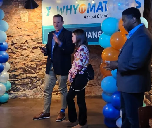 a man speaking at a YMCA event