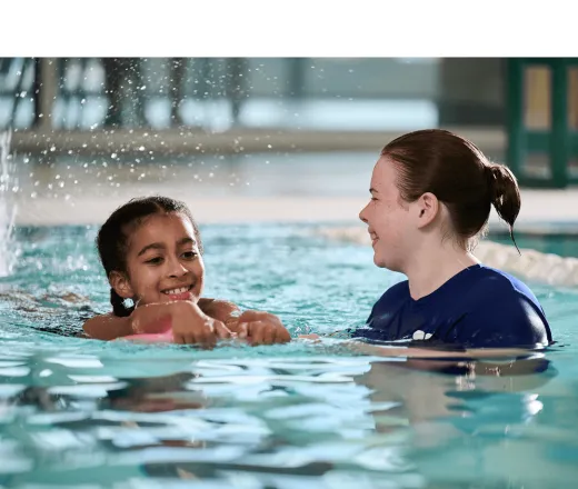 swim lesson instructor teaching a swim lesson