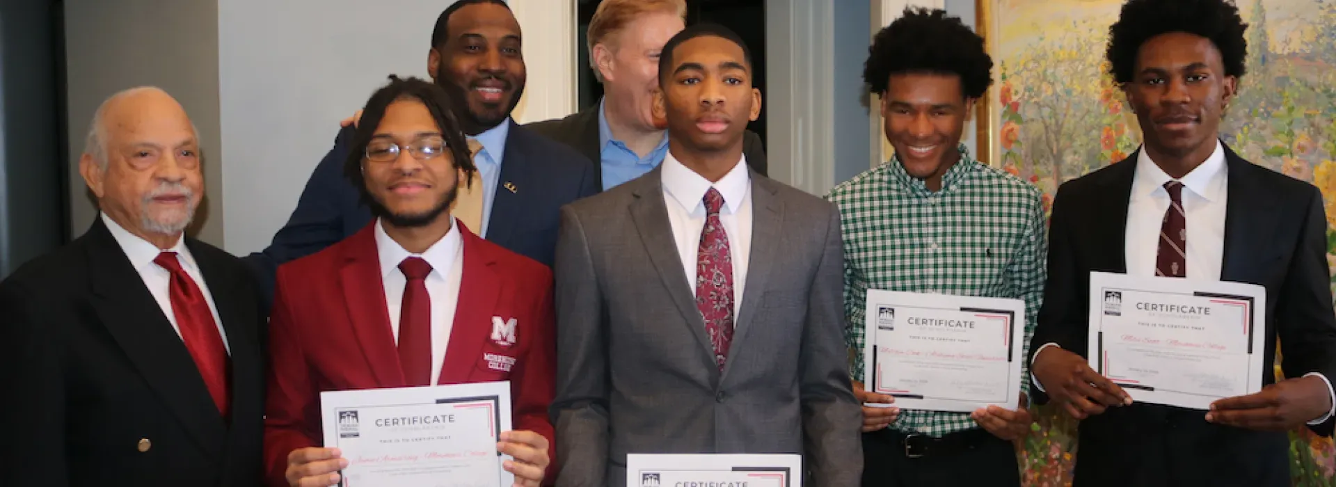 group of people standing receiving a certificate
